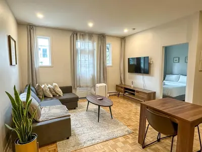 a living room with a couch and a table at Lovely One-Bedroom in Vibrant Plateau Mont-Royal in Montréal