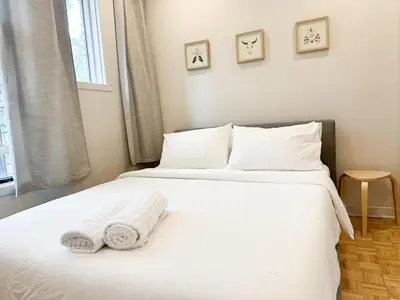 a bedroom with two beds with white sheets and pillows at Lovely One-Bedroom in Vibrant Plateau Mont-Royal in Montréal
