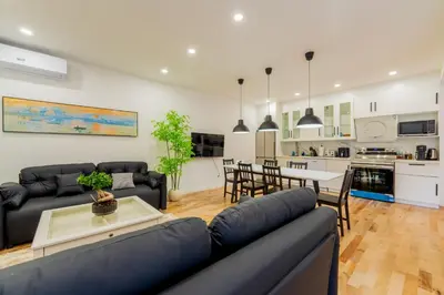 a living room with a couch and a table at Newly Renovated 3BR 2BA Spacious and Modern in Montréal
