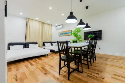 a living room with a table and chairs and a couch at Newly Renovated 3BR 2BA Spacious and Modern in Montréal