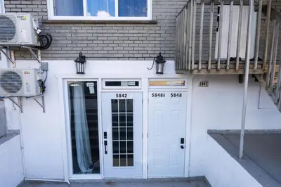 a building with a white door and a balcony at Renovated Studio w Parking Queen Bed and Sofa Bed in Montréal