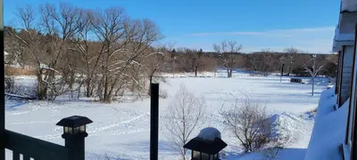 a view of a snow covered field from a house at Manoir Hunting 1869 in Waterville