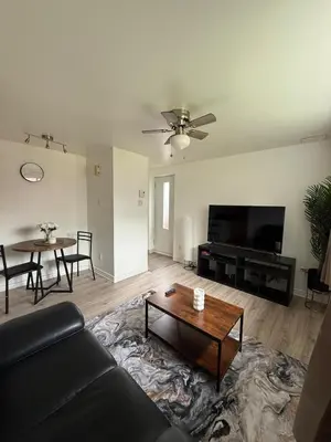 a living room with a couch and a table at Studio, Near Montreal in Repentigny
