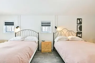 two beds sitting next to each other in a bedroom at Suite 3 - Val-Racine in Notre-Dame-Des-Bois