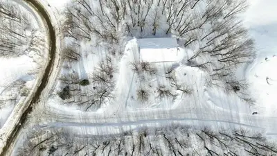 an aerial view of a snow covered road with trees at Suite 3 - Val-Racine in Notre-Dame-Des-Bois