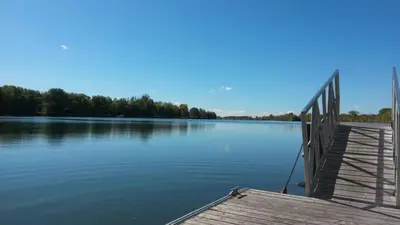a dock on a body of water with trees at Bright 2BR Near River Private Parking in McMasterville