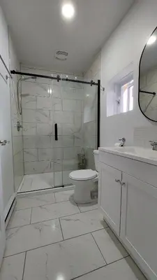 a bathroom with a shower and a toilet and a sink at Bright 2BR Near River Private Parking in McMasterville