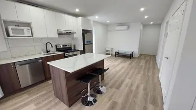 a kitchen with white cabinets and a white counter top at Bright 2BR Near River Private Parking in McMasterville