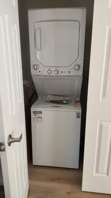 a small refrigerator with a tv on top of it at Bright 2BR Near River Private Parking in McMasterville
