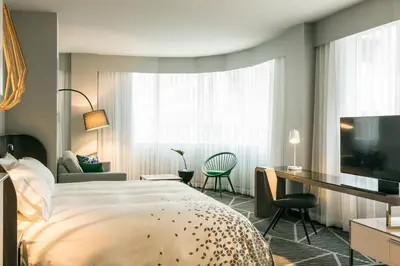 a hotel room with a bed and a desk at Renaissance Montreal Downtown Hotel in Montréal