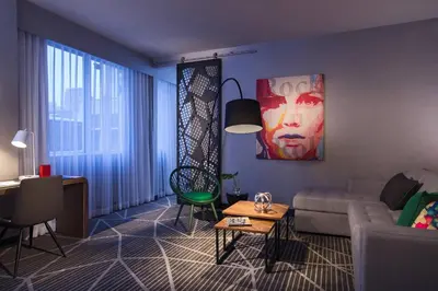 a living room with a couch and a table at Renaissance Montreal Downtown Hotel in Montréal