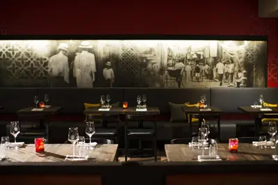 a dining room with tables and chairs and a painting at Renaissance Montreal Downtown Hotel in Montréal