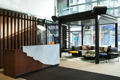 a lobby with a couch and a table at Renaissance Montreal Downtown Hotel in Montréal