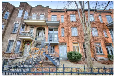 a brick building with a staircase in front of it at Condo lumineux au cœur du Mile-end in Montréal
