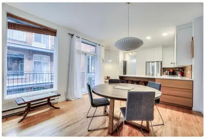 a kitchen and dining room with a table and chairs at Condo lumineux au cœur du Mile-end in Montréal