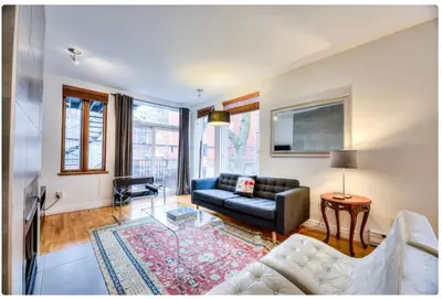 a living room with a couch and a table at Condo lumineux au cœur du Mile-end in Montréal
