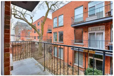 an empty balcony of a brick building at Condo lumineux au cœur du Mile-end in Montréal