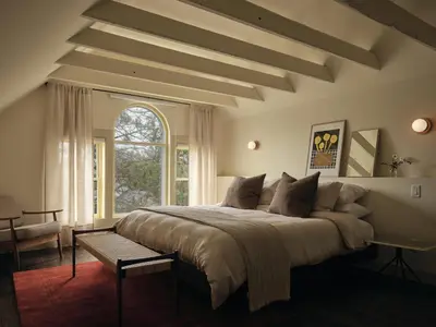 a bedroom with a large bed and a window at Pinôt Boutique Hôtel in Sutton