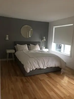 a bedroom with a large bed and a window at Lovely 2 bedroom in little burgandy in Montréal