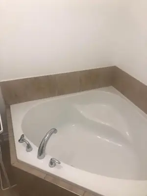 a bath tub with a faucet in a bathroom at Lovely 2 bedroom in little burgandy in Montréal