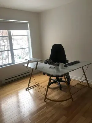 a table and a chair in a room with a desk at Lovely 2 bedroom in little burgandy in Montréal