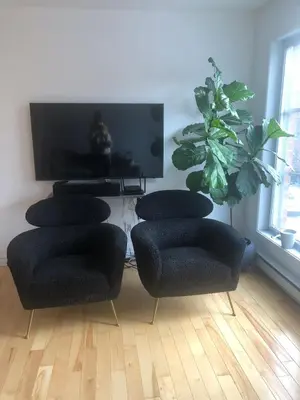 a living room with four chairs and a flat screen tv at Lovely 2 bedroom in little burgandy in Montréal
