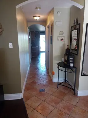 a hallway with a tile floor and a table at Cozy 2 bedroom close to downtown in Montréal