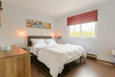 a bedroom with a large bed and a window at Cozy 2 bedroom close to downtown in Montréal