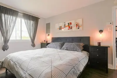 a bedroom with a large bed and a window at Cozy 2 bedroom close to downtown in Montréal