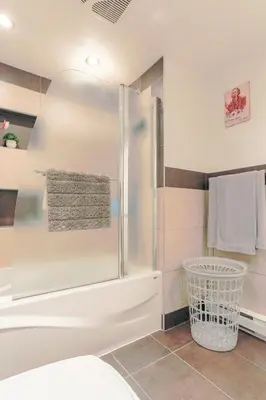 a bathroom with a shower with a towel at Cozy 2 bedroom close to downtown in Montréal