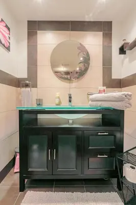 a bathroom with a sink and a mirror at Cozy 2 bedroom close to downtown in Montréal