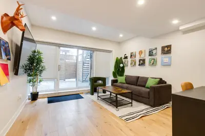 a living room with a couch and a table at Spacious 1BDR unit with Private Patio and Parking by M11 in Montréal