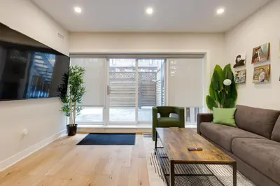 a living room with a couch and a table at Spacious 1BDR unit with Private Patio and Parking by M11 in Montréal