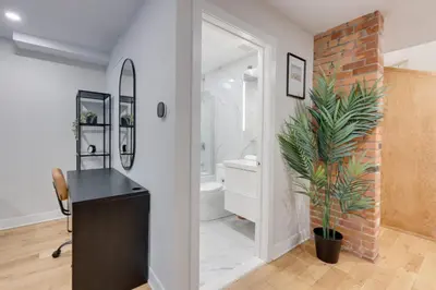 a bathroom with a black desk and a brick wall at Spacious 1BDR unit with Private Patio and Parking by M11 in Montréal