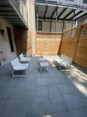 a patio with chairs and benches on a building at Spacious 1BDR unit with Private Patio and Parking by M11 in Montréal
