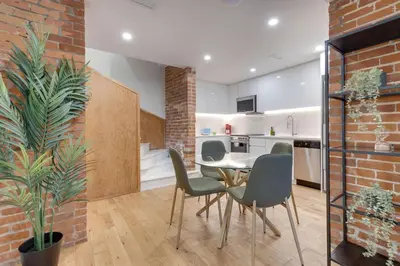 a kitchen and dining room with a table and chairs at Spacious 1BDR unit with Private Patio and Parking by M11 in Montréal