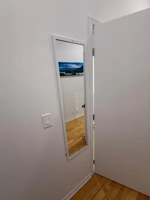 a door with a mirror in a room at 1 bedroom apartment near Montreal downtown with parking in Montréal