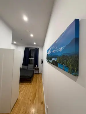 a living room with a large painting on the wall at 1 bedroom apartment near Montreal downtown with parking in Montréal