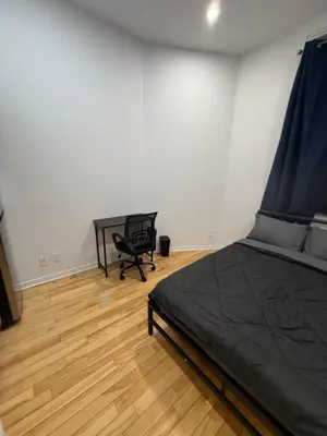 a bedroom with a bed and a desk and a chair at Well located studio with Parking near Downtown Montreal in Montréal