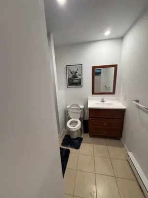 a bathroom with a toilet and a sink and a mirror at Well located studio with Parking near Downtown Montreal in Montréal