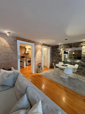 a living room with a couch and a table at Le Old World Meets Modern in Montréal