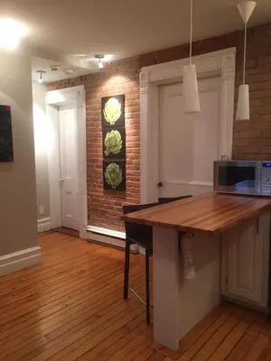 a kitchen with a wooden counter top in a room at Le Old World Meets Modern in Montréal