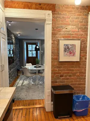 a kitchen and dining room with a brick wall at Le Old World Meets Modern in Montréal