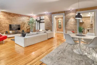 a living room with a couch and a table at Le Old World Meets Modern in Montréal