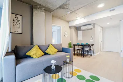 a living room with a blue couch and a table at Bright 1BR Apt with Convertible Armchair in Montréal