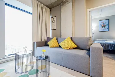a living room with a couch and a bed at Bright 1BR Apt with Convertible Armchair in Montréal