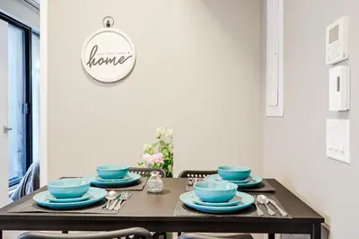 a dining room table with blue dishes on it at Bright 1BR Apt with Convertible Armchair in Montréal