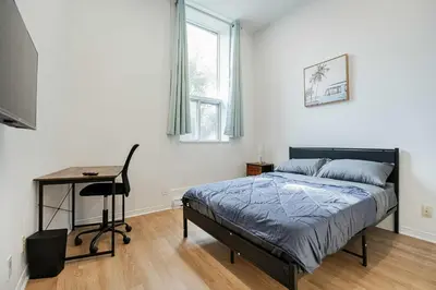 a bedroom with a bed and a desk in it at Beautiful 3 person 2 Beds Studio with parking near downtown Montreal in Montréal