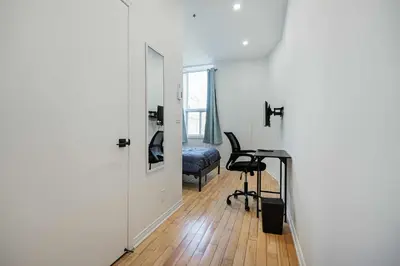 a room with a desk and a chair and a door at Escape studio with parking near downtown Montreal in Montréal