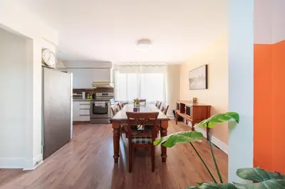 a kitchen and dining room with a table and chairs at 3 bedrooms in Brossard,mins to REM station,hwy in Brossard